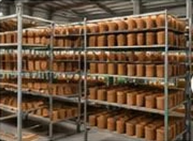 Shelving racks full of drying coir pots