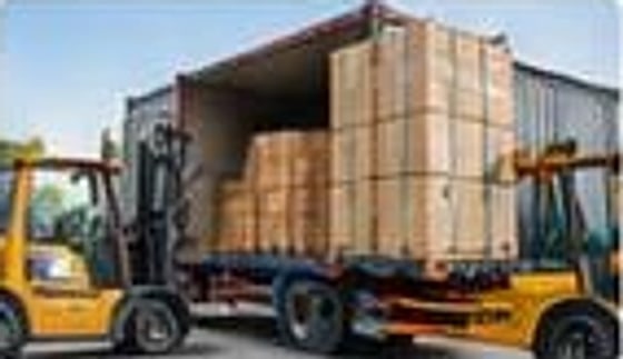 Forklift loading a container