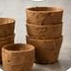 Molded coir pots stacked after pressing