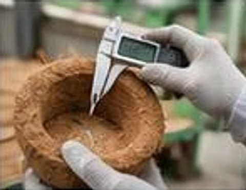 Measuring a coir product with calipers